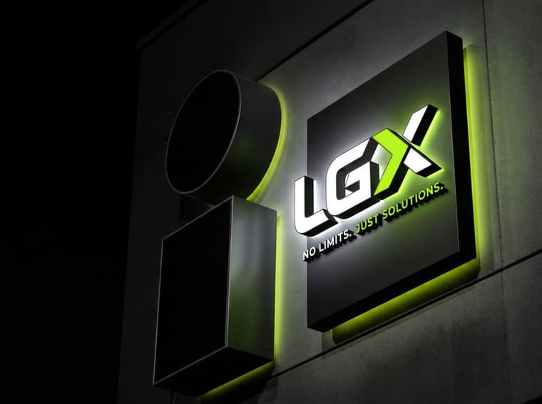 Illuminated LGX channel letter sign mounted on a building at night