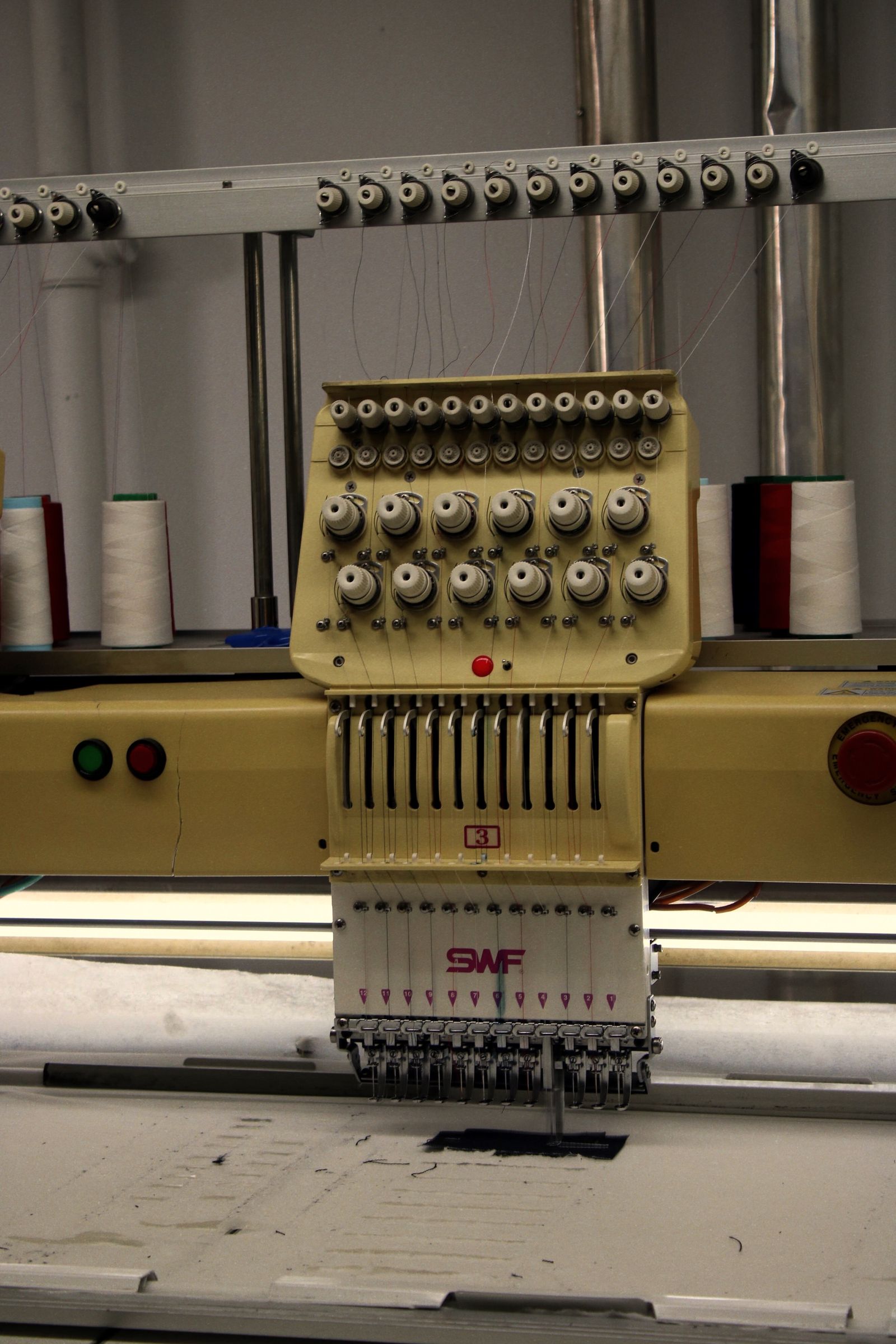 Embroidery machine stitching a design